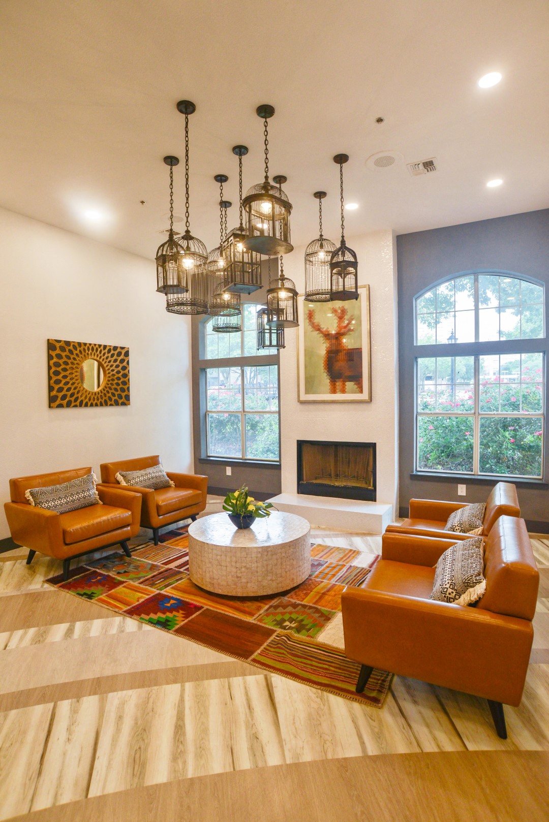 a living room with orange couches and chairs and a fireplace
